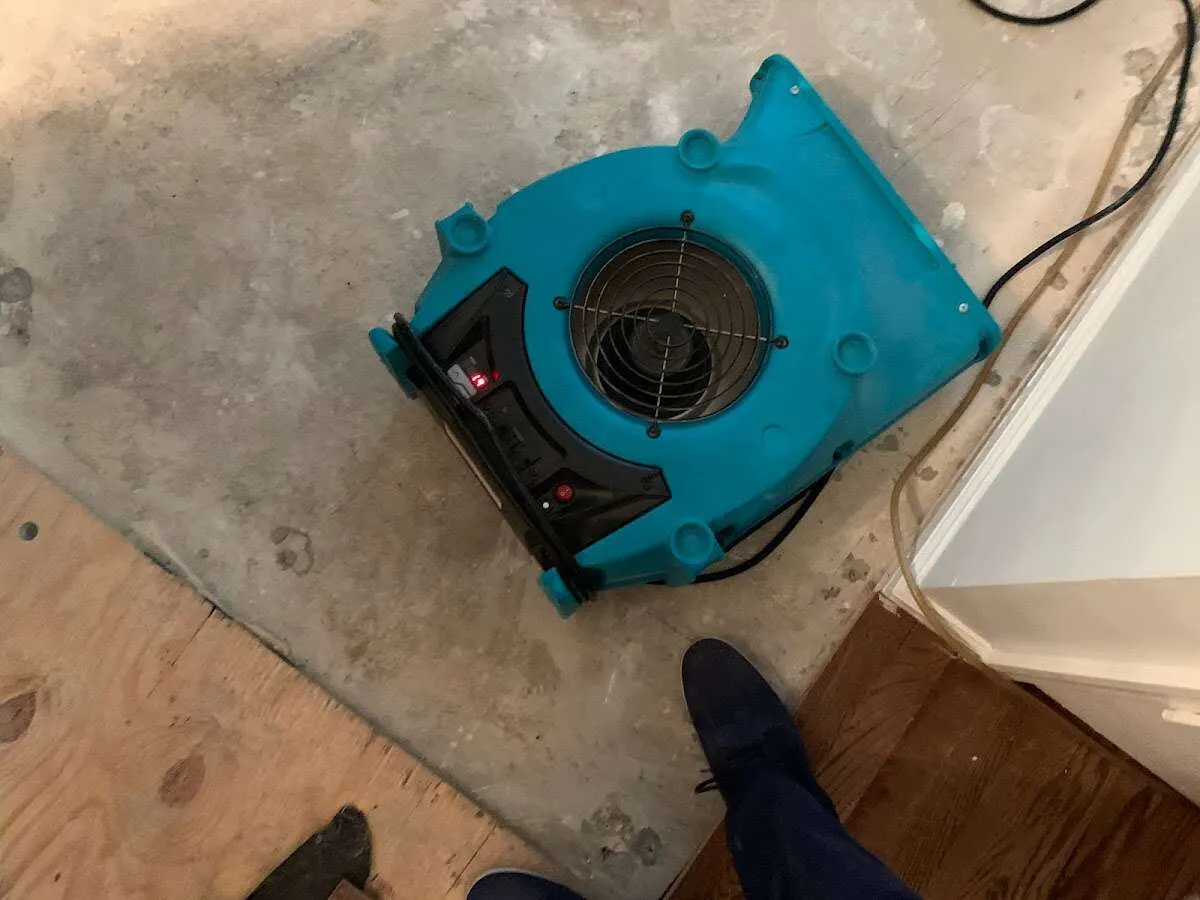 Air mover drying subfloor during Leak Detection & Repair in Warsaw